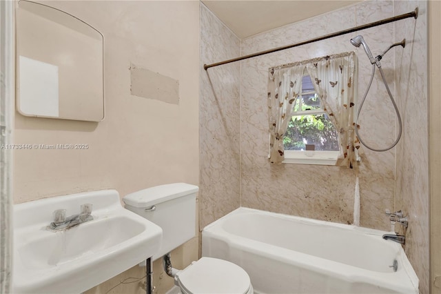 full bathroom with sink, tiled shower / bath combo, and toilet