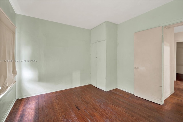 spare room featuring dark wood-type flooring