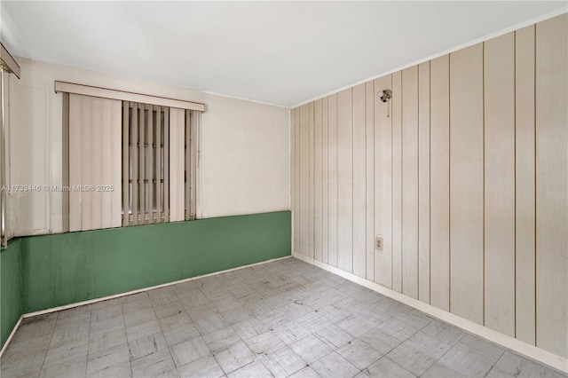 empty room featuring wood walls