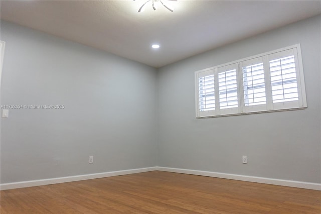 spare room with hardwood / wood-style flooring