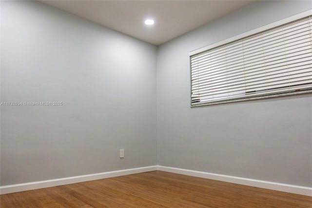 unfurnished room with wood-type flooring