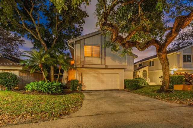 view of front of property with a garage and a front lawn