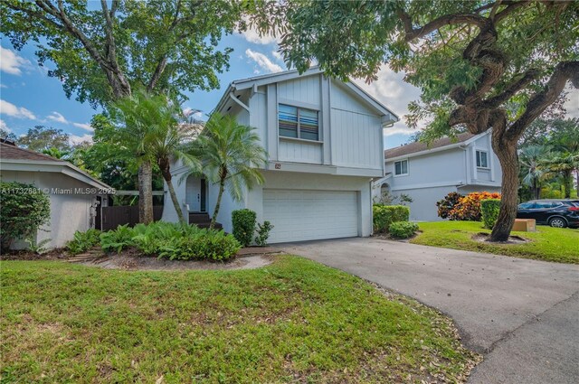 view of front of property featuring a garage and a front yard