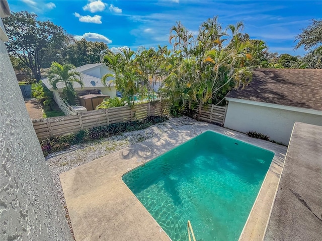 view of pool with a fenced backyard