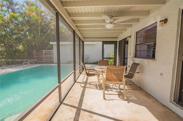 sunroom featuring ceiling fan and beamed ceiling