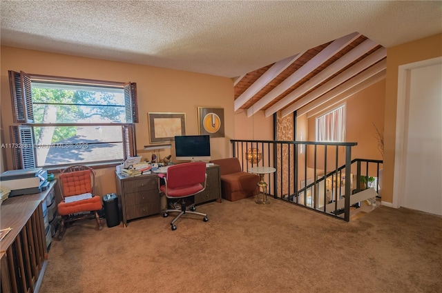 carpeted office with lofted ceiling with beams and a textured ceiling