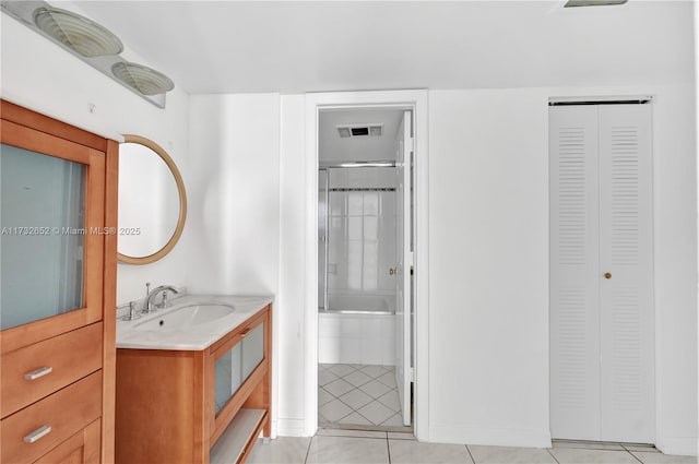 bathroom featuring vanity, tile patterned flooring, and walk in shower