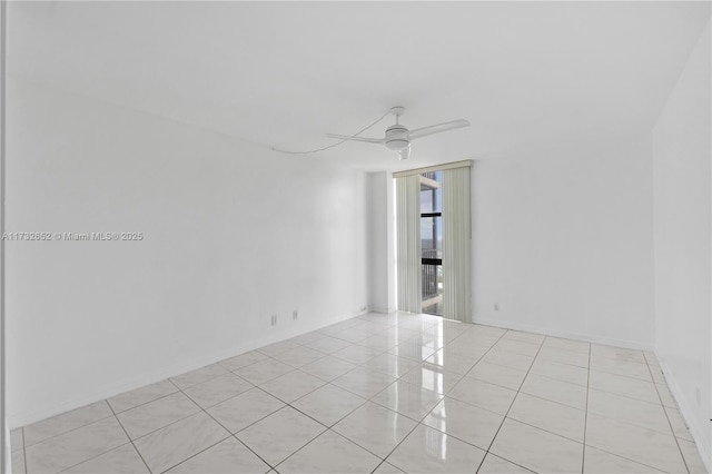 tiled empty room featuring ceiling fan