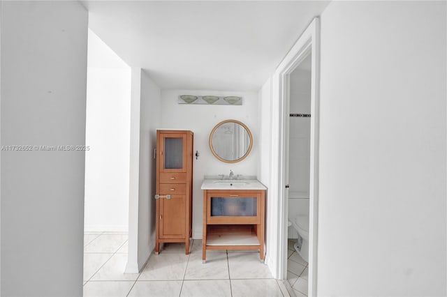 bathroom featuring vanity, toilet, and tile patterned flooring