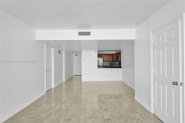 unfurnished room with light tile patterned floors