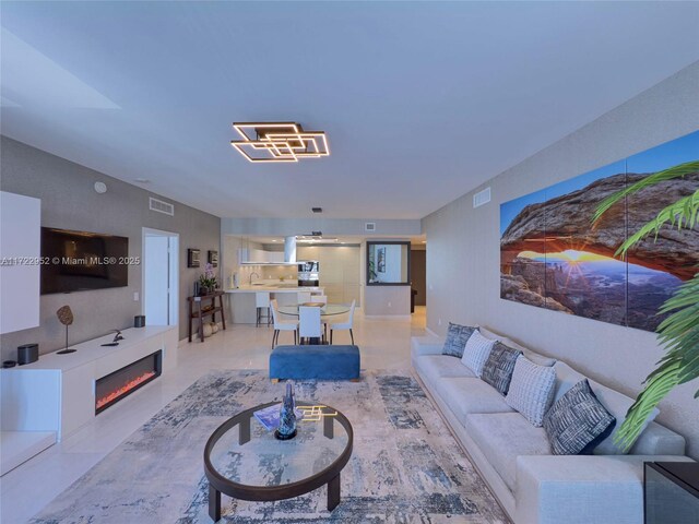17111 Biscayne Blvd Unit 1705, North Miami Beach, FL 33160 - living area featuring a glass covered fireplace
