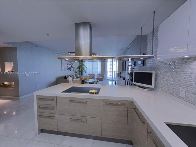 kitchen with light tile patterned flooring, black electric stovetop, light brown cabinetry, and decorative backsplash