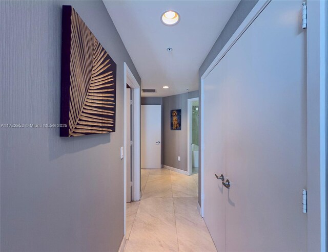 hall featuring light tile patterned floors