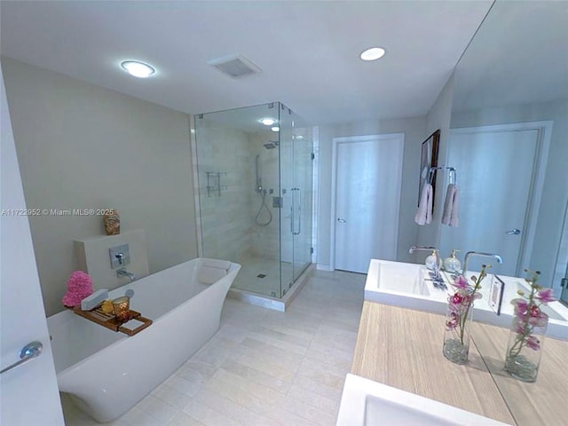 bathroom with vanity and separate shower and tub