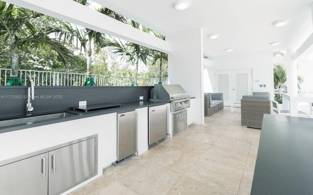 view of patio featuring exterior kitchen, a grill, and sink