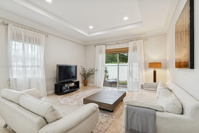 living area featuring baseboards, a tray ceiling, crown molding, and recessed lighting