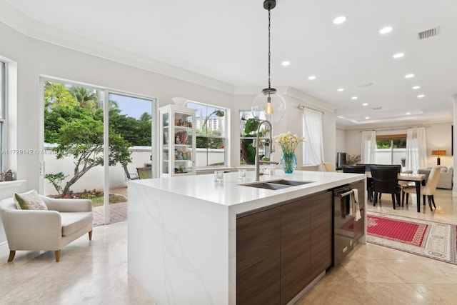 kitchen featuring modern cabinets, visible vents, light countertops, and a sink