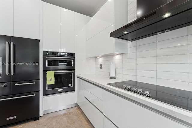 kitchen featuring range hood, decorative backsplash, white cabinets, modern cabinets, and black appliances