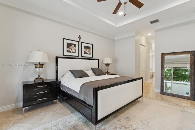 bedroom featuring ensuite bathroom, visible vents, baseboards, ornamental molding, and a tray ceiling