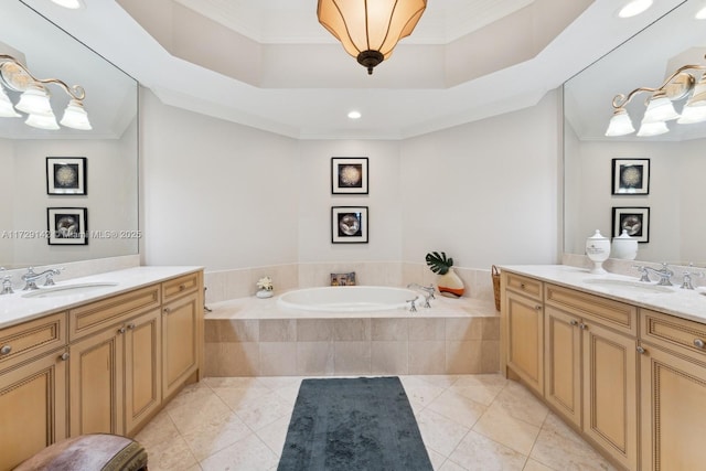 bathroom with two vanities, a sink, and a bath