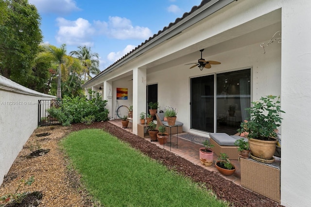 view of yard with a patio, fence, and ceiling fan