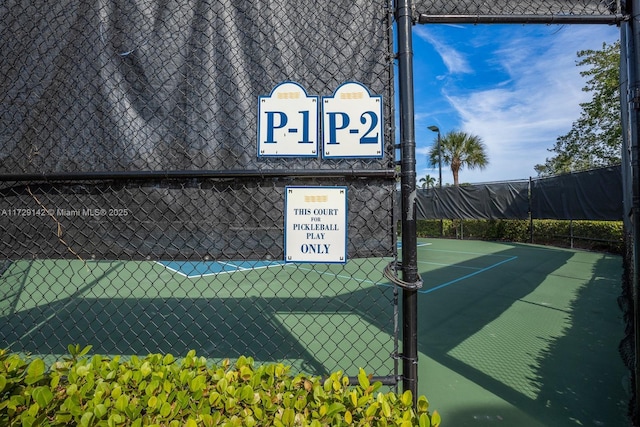 view of tennis court with fence