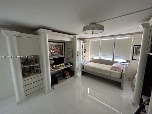 tiled bedroom with decorative columns