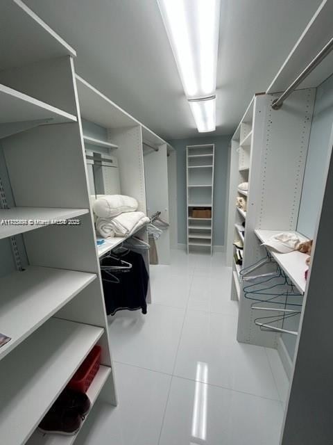 walk in closet featuring light tile patterned floors