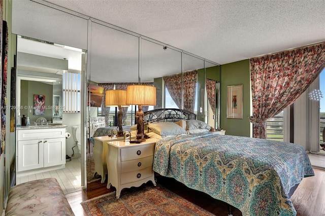 bedroom with sink and a textured ceiling