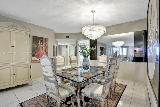 tiled dining room with a textured ceiling and an inviting chandelier