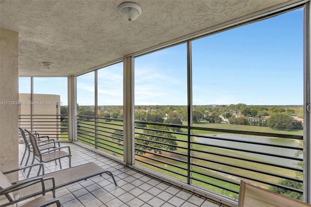 unfurnished sunroom with a water view