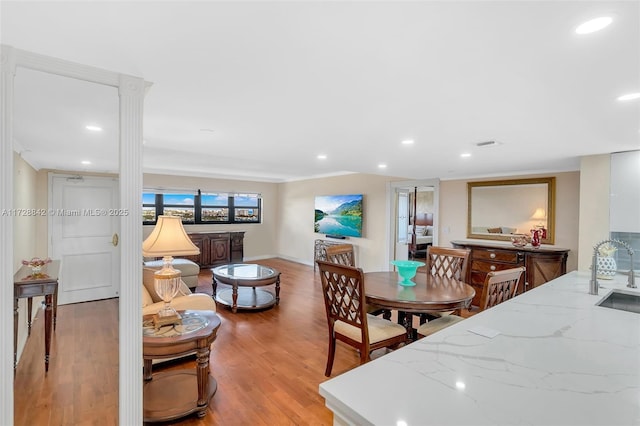 dining area featuring sink and light hardwood / wood-style floors