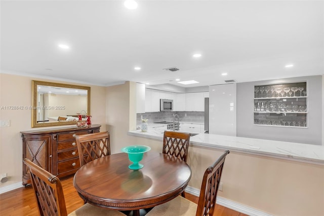 dining space with light hardwood / wood-style floors