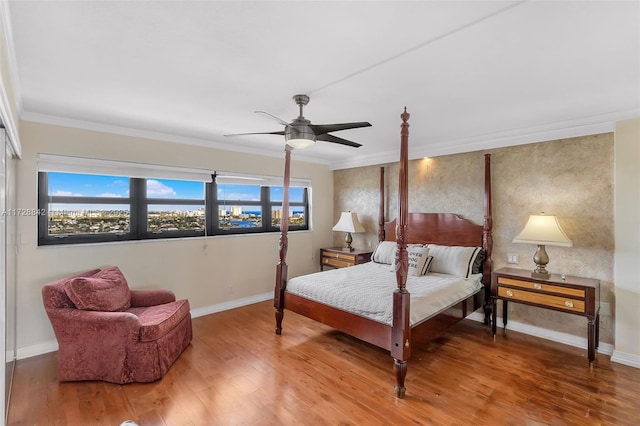 bedroom with ornamental molding, wood-type flooring, and ceiling fan