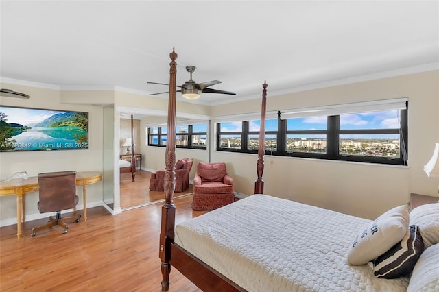 bedroom featuring hardwood / wood-style flooring, ceiling fan, and crown molding