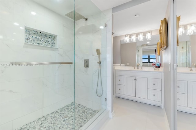 bathroom with vanity, tile patterned flooring, and tiled shower