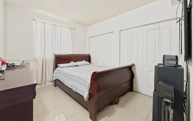 tiled bedroom with multiple closets