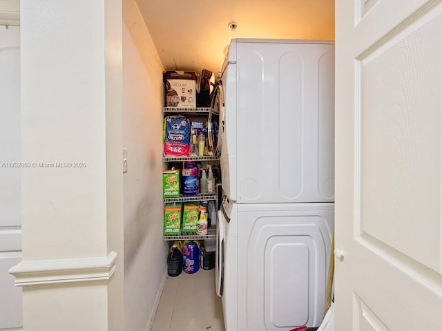 pantry featuring stacked washer and clothes dryer