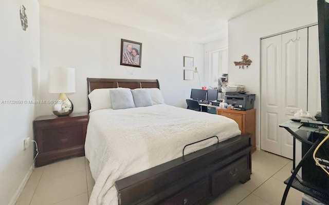 bedroom featuring a closet and light tile patterned floors