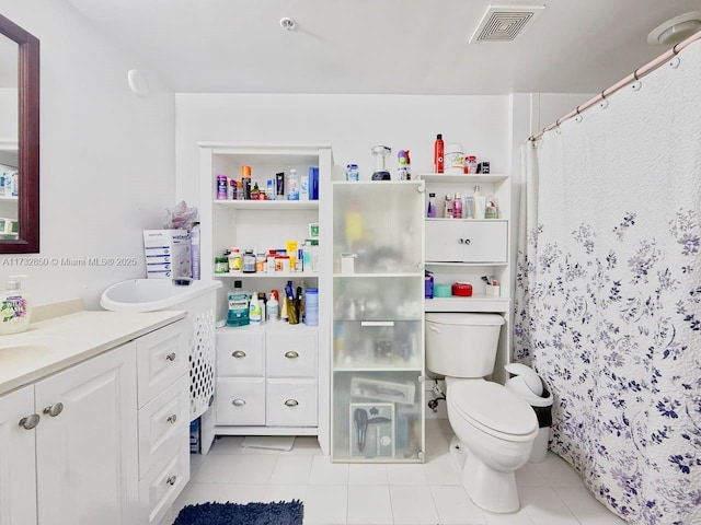 bathroom with vanity, tile patterned flooring, and toilet