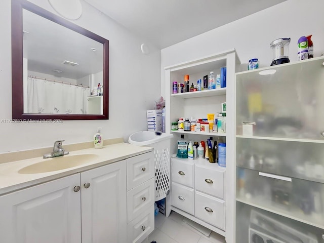 bathroom with vanity and tile patterned flooring