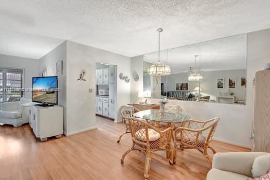 dining area with hardwood / wood-style flooring and a textured ceiling