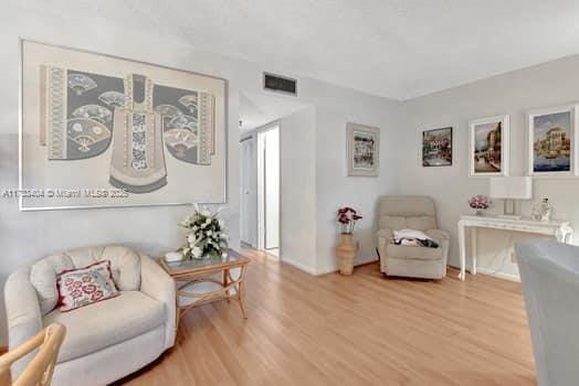 sitting room with hardwood / wood-style floors