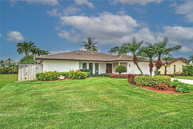 ranch-style home with a front lawn