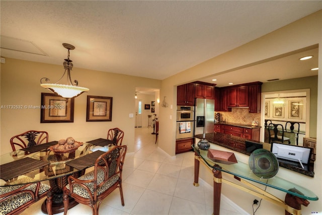 dining room with light tile patterned flooring and a textured ceiling