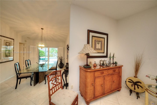 tiled dining area with vaulted ceiling and a chandelier