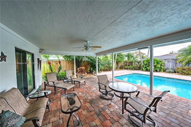 view of pool with ceiling fan and a patio area