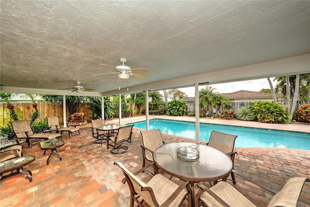 view of swimming pool with a patio and ceiling fan