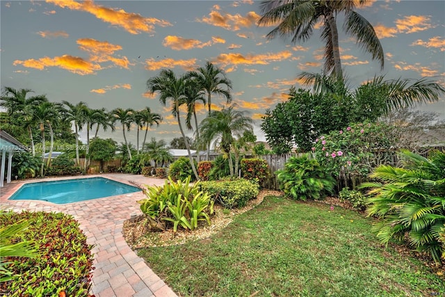 pool at dusk featuring a patio area