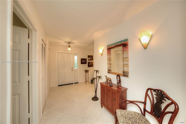 entrance foyer featuring light tile patterned floors and a textured ceiling